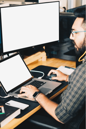 Man Working On A Computer And Laptop